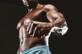 Confident muscular black guy showing strong fist to camera