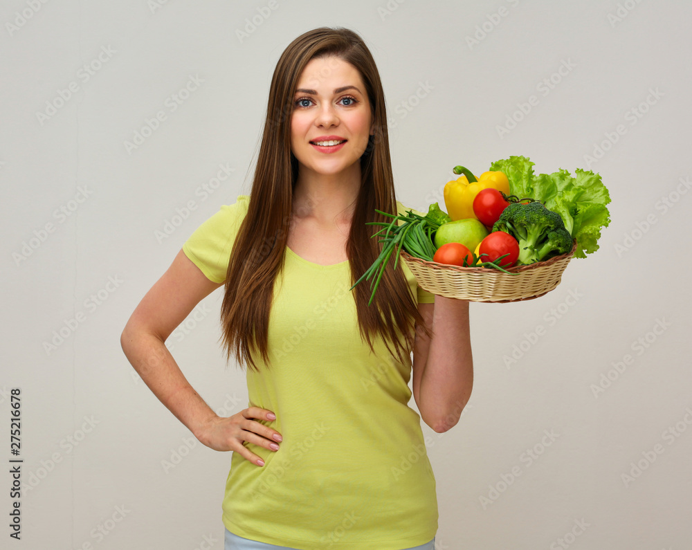 woman with toothy smile holding straw basket vith vegetarian fod set. woman with toothy smile holding straw basket vith vegetarian fod set.