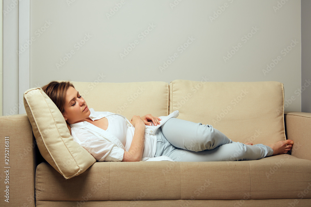 Woman resting lying on the sofa