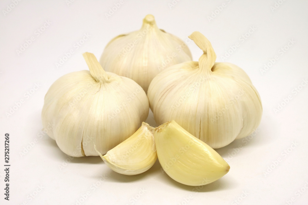 Garlic Bulbs and Peeled Garlic Cloves Isolated on White Background Garlic Bulbs and Peeled Garlic Cloves Isolated on White Background
