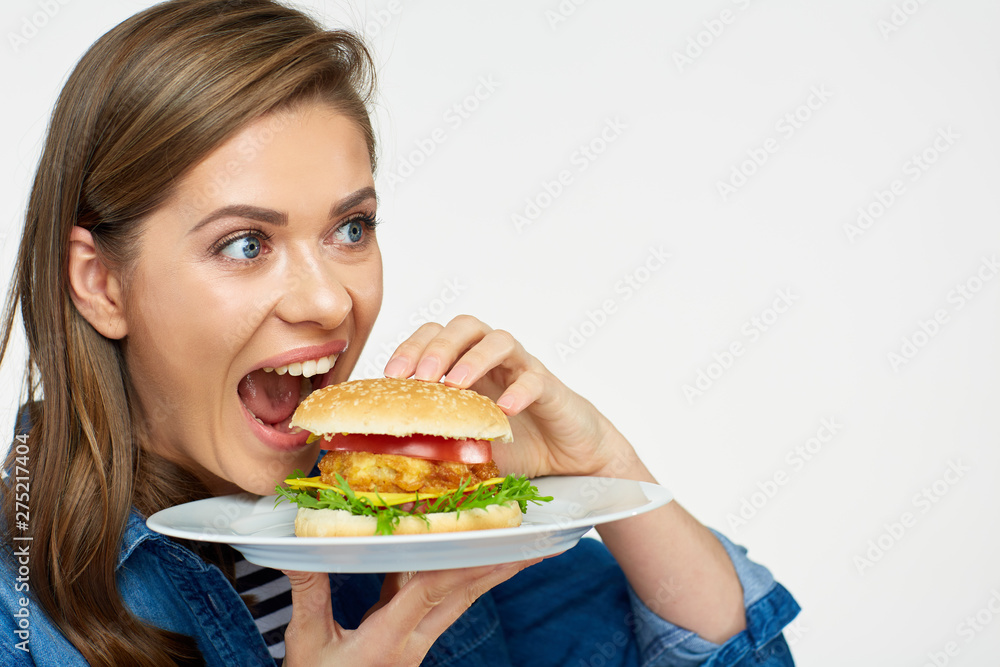 close up portrait of hungry woman biting burger