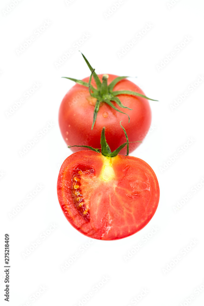 fresh tomato and half a tomato with dew drops isolated on white background fresh tomato and half a tomato with dew drops isolated on white background