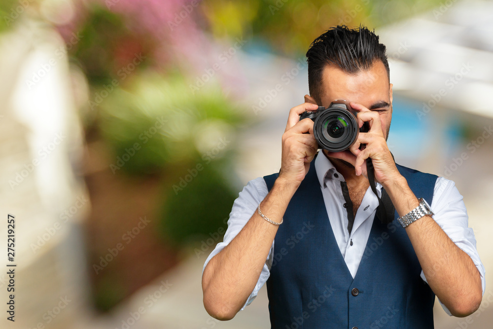 east asian handsome man taking a shot with camera east asian handsome man taking a shot with camera