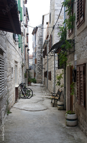 Stone houses in narrow street of old town  beautiful architecture  sunny day  Trogir  Dalmatia  Croatia