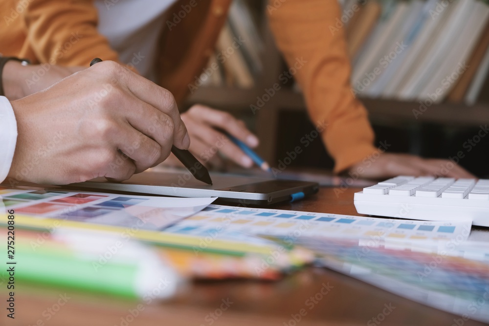 Graphic designer working on digital tablet. artist drawing on graphic tablet and Color swatch samples. Graphic designer working on digital tablet. artist drawing on graphic tablet and Color swatch samples.