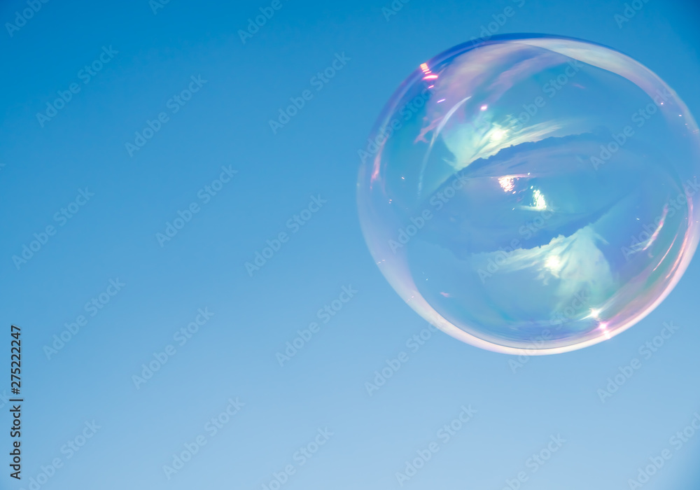 Large, soap bubbles against the blue sky. Lake Ladoga, sunny day. Large, soap bubbles against the blue sky. Lake Ladoga, sunny day.