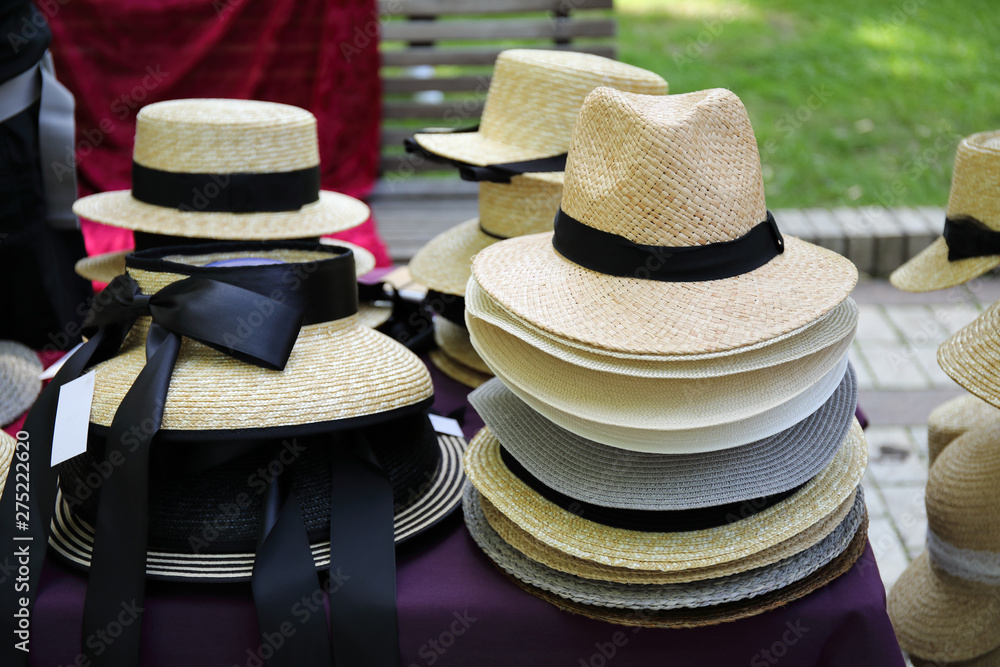 several straw hats in a street market