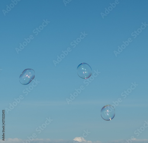 Large  soap bubbles against the blue sky. Lake Ladoga  sunny day.