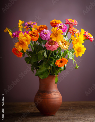 bouquet of summer flowers in a jar on wooden table