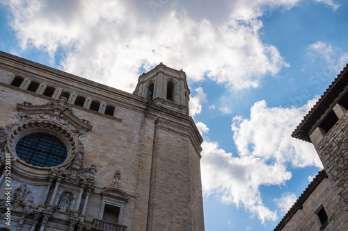 Girona's Cathedral main landmark, high church tower on a diagonal composition on a blue cloudscape