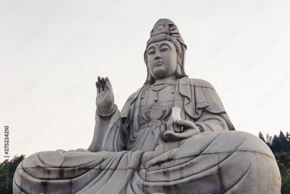 Stone sitting Buddha statue in peaceful location