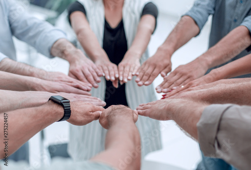 close up.young business team forming a circle of hands © ASDF