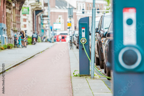 Sticker EV Car or Electric car at charging station with the power cable supply plugged