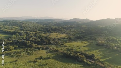 Drone footage panning motion to the right revealing far mountains during a sunrise. photo