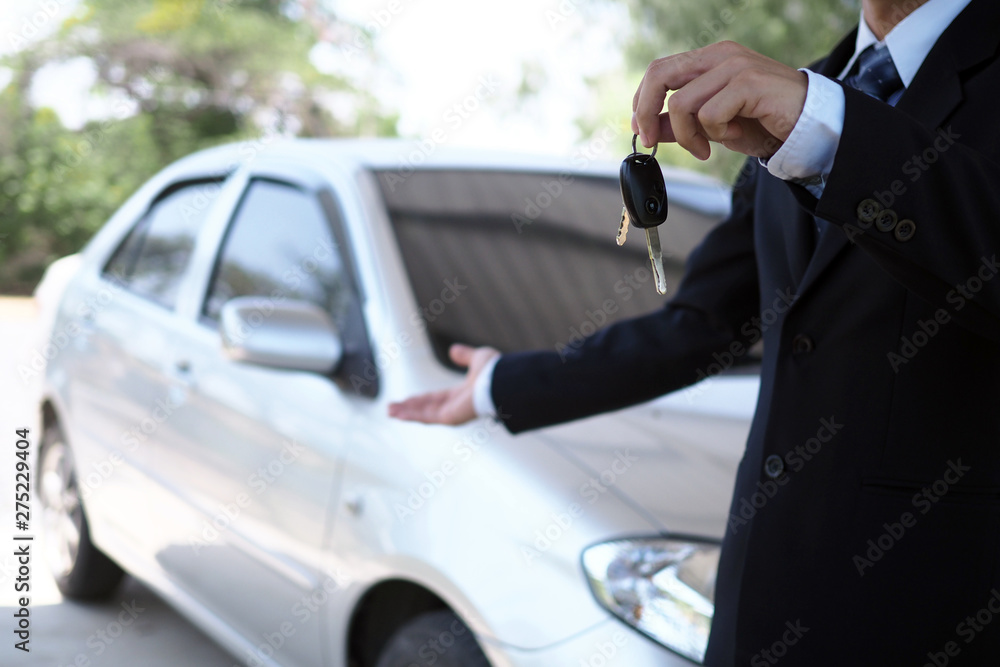 Car salesmen and keys presenting car trading Car salesmen and keys presenting car trading