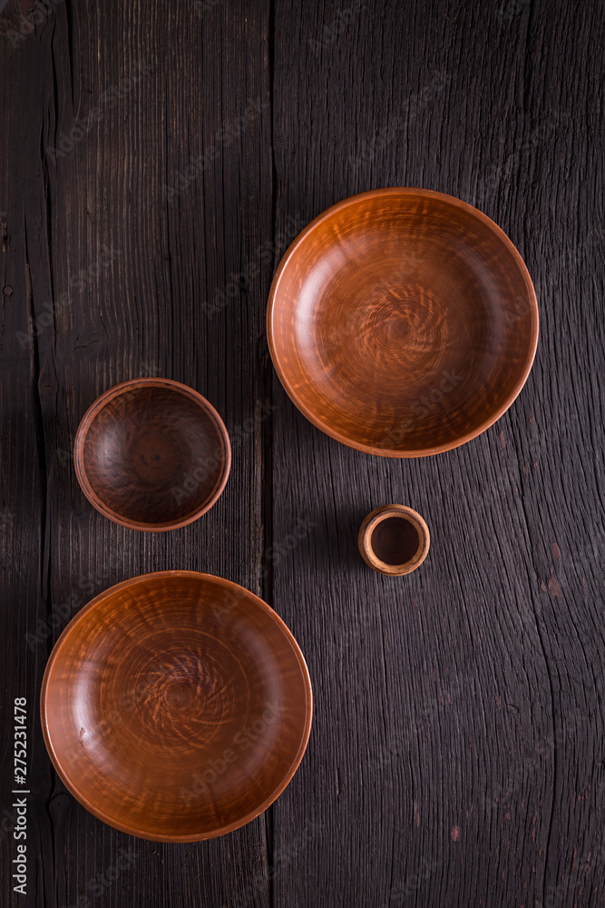 Empty clay bowls on a wooden table. Top view. Concept: food. Empty clay bowls on a wooden table. Top view. Concept: food.