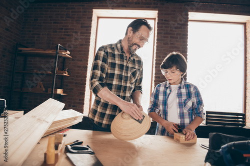 Portrait of parenthood daddy teacher show son professional occupation brunettes hair hairstyle bearded checked shirt indoors home workstation glasses goggles protective photo