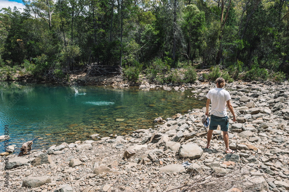 skipping stones in Blue river at Douglas Apsley National Park Tasmania Australia skipping stones in Blue river at Douglas Apsley National Park Tasmania Australia