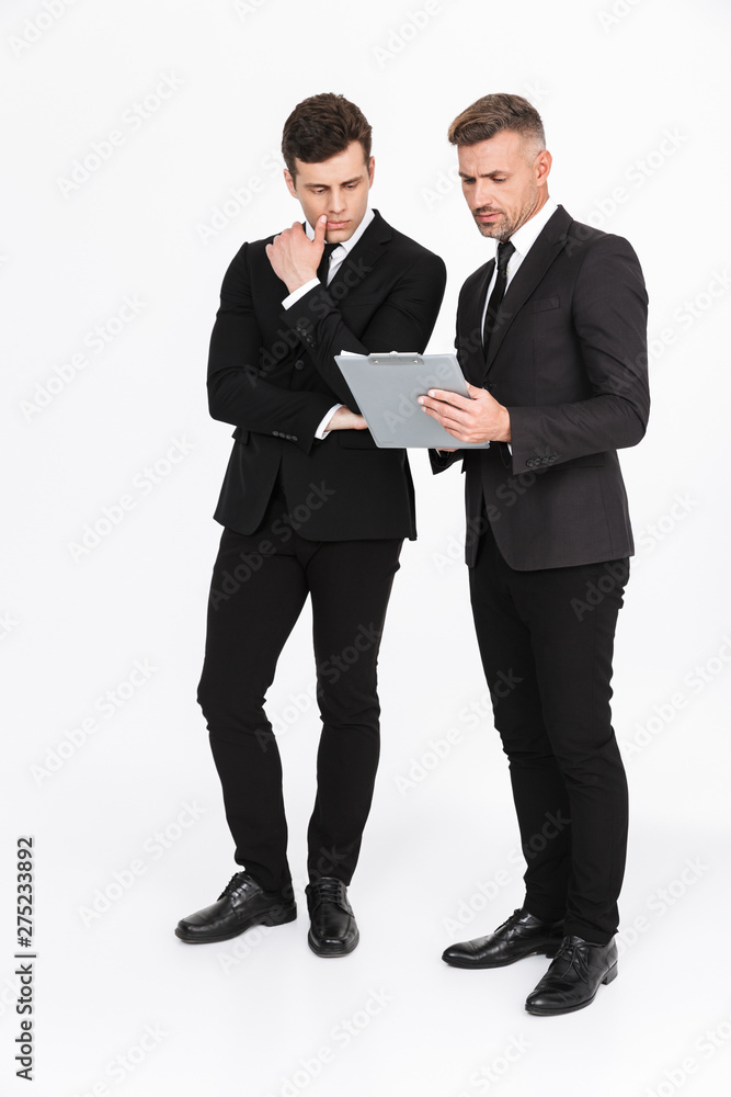 Two attractive confident businessmen wearing suits Two attractive confident businessmen wearing suits
