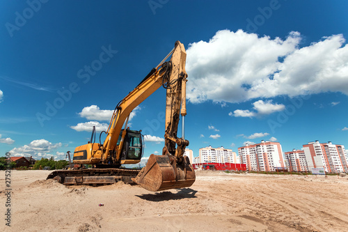 Excavator on a construction site against a blue sky. Construction  technology