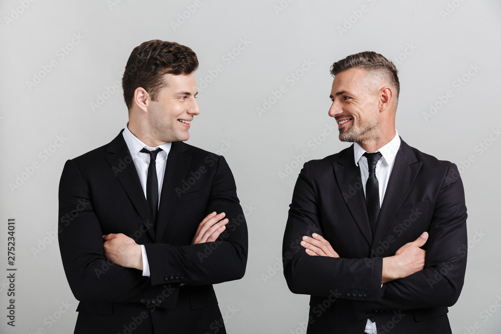 Two attractive confident businessmen wearing suits Two attractive confident businessmen wearing suits