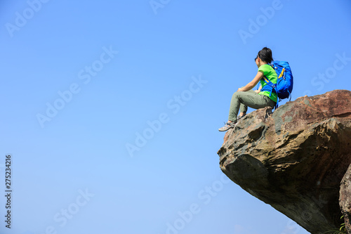 Successful woman hiker enjoy the view hiking on mountain peak