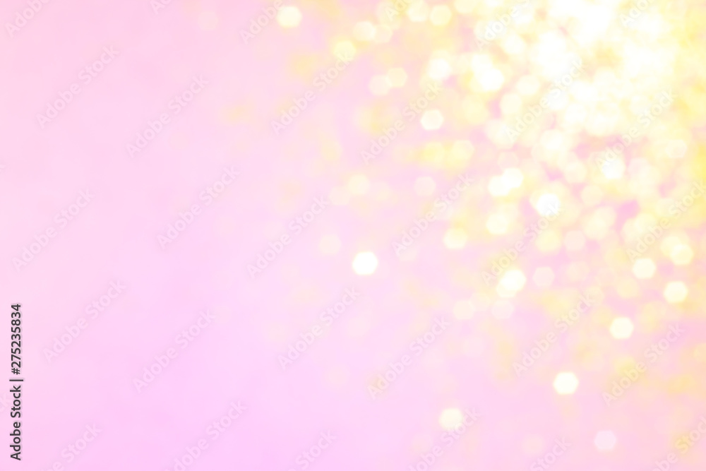 Blurred background - pink surface with gold sparkles. Abstract image. Bright color. Abstract circular bokeh.