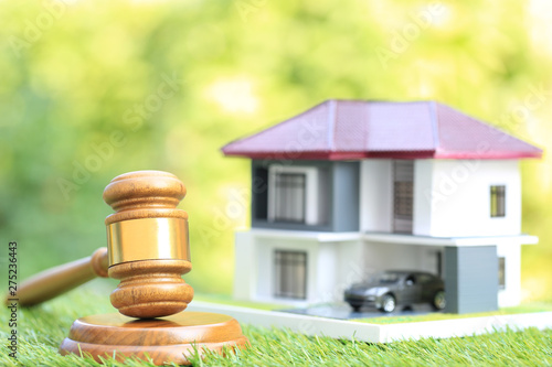 Property auction, Gavel wooden and model house on natural green background, lawyer of home real estate and ownership property concept photo