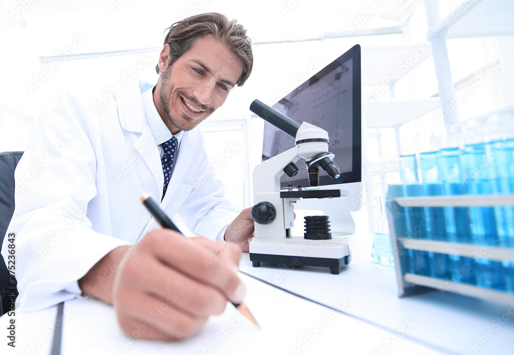 scientist makes a note of experiment in the laboratory scientist makes a note of experiment in the laboratory