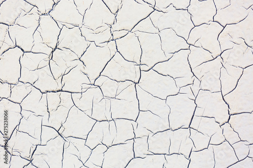 Old vintage cracked white painted wall texture pattern. Grungy wall background.