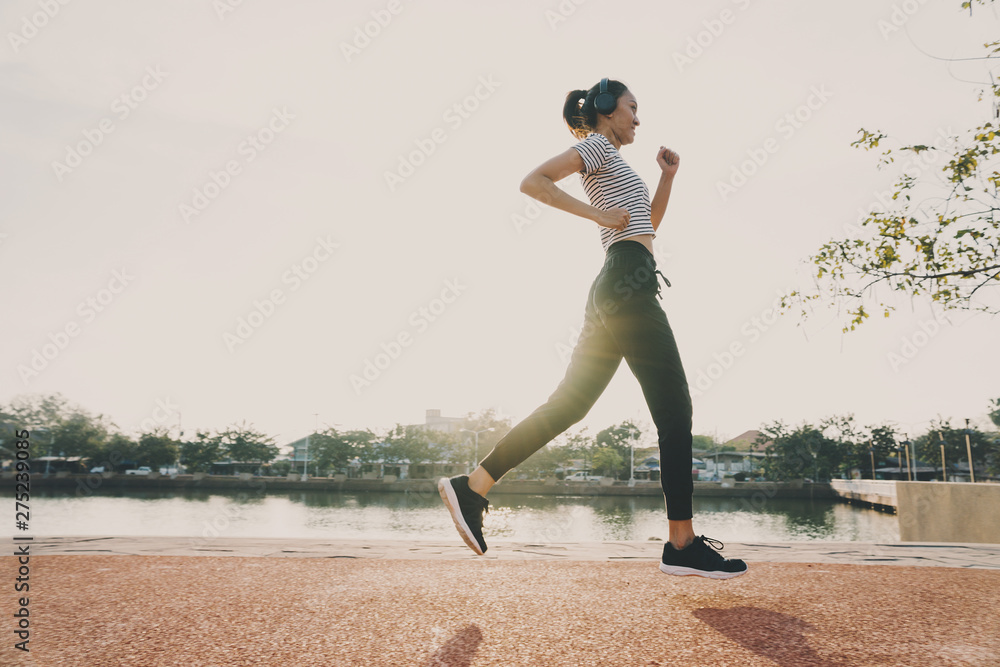 Healthy woman doing exercises and warm up before running and jogging at morning