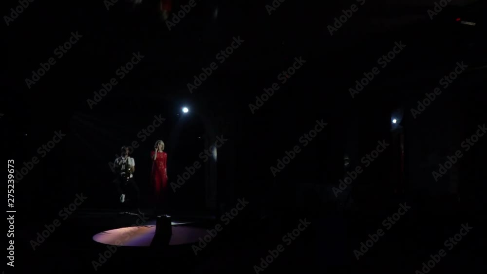 Dramatic lighting, duet of musicians are performing on stage Dramatic lighting, duet of musicians are performing on stage