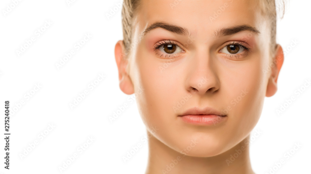 Portrait of young serious woman with light makeup on white background Portrait of young serious woman with light makeup on white background