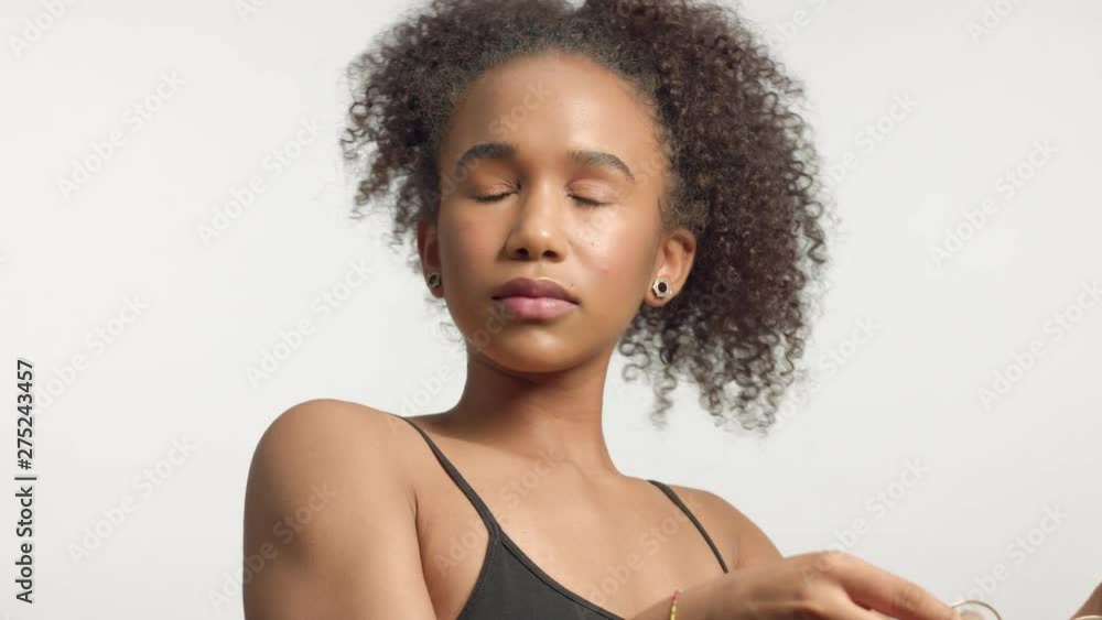 beauty mixed race model with curly hair take off her glasses and watching to the camera beauty mixed race model with curly hair take off her glasses and watching to the camera