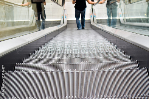 A man downing the escalator in shopping mall