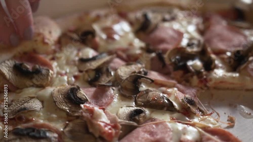 Side View - A Woman Takes A Portion Of Pizza photo