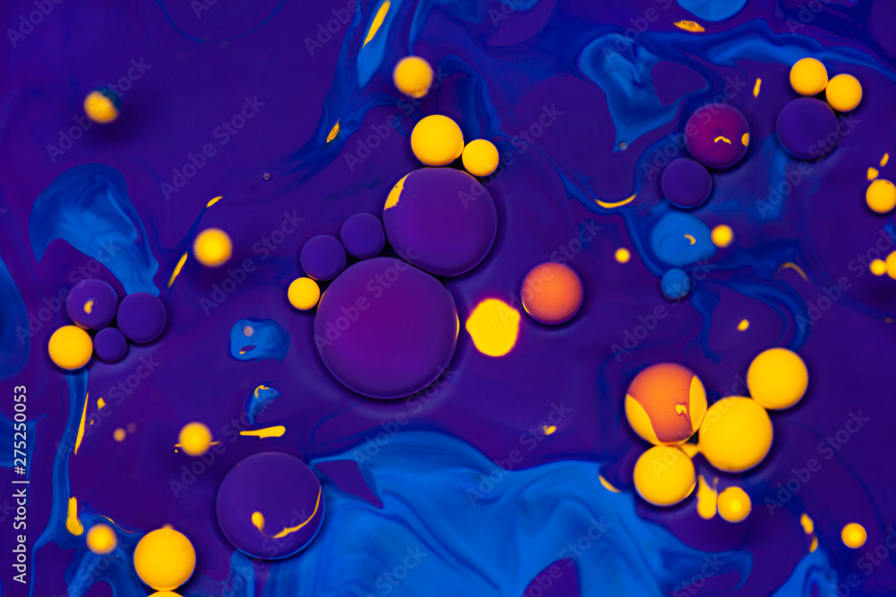 Fototapeta Acrylic paint balls abstract texture. Purple, blue and yellow liquids mix. Creative multicolor background.