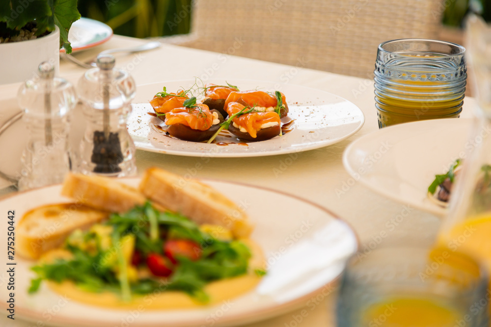 Nourishing snacks and bruschetta near orange juice Nourishing snacks and bruschetta near orange juice