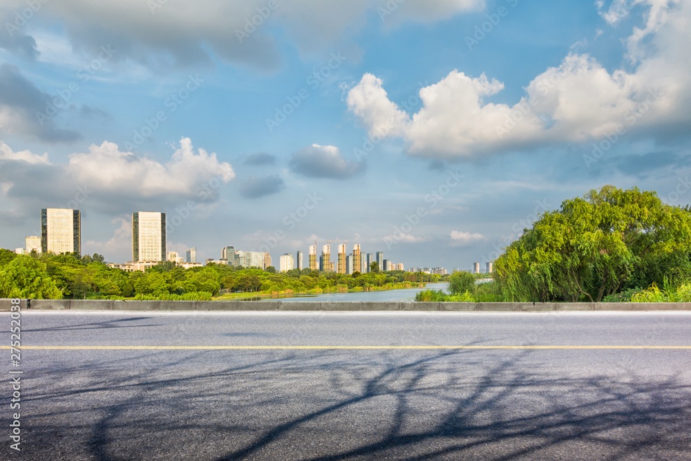 Timelapse hyperlapse view on skyscrapers at waterfront with palms. Residential buildings covered with glass in Jumeirah Lake Towers reflected in water in Dubai, UAE. The JLT is a large developmen