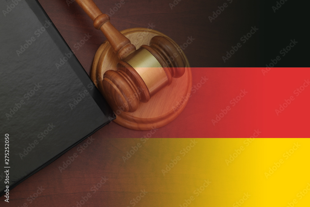 Law concept, judge gavel and legal book on wooden table, collage with german flag