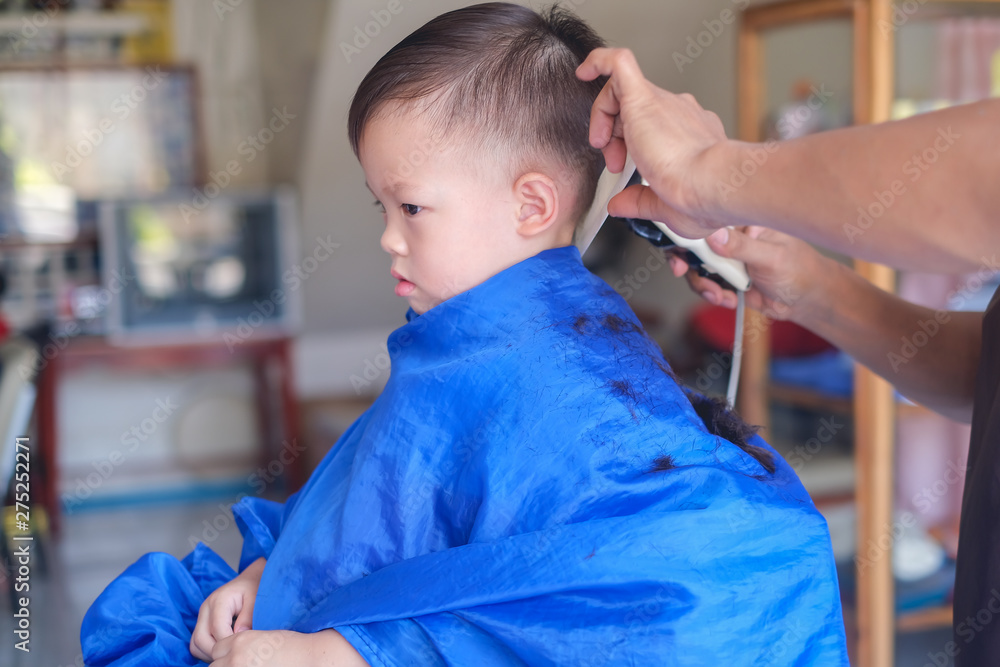 Cute worried little Asian 3 years old toddler baby boy child getting a  haircut at the hairdresser's barber shop, Kid cut with hairdresser's  machine Stock Photo | Adobe Stock