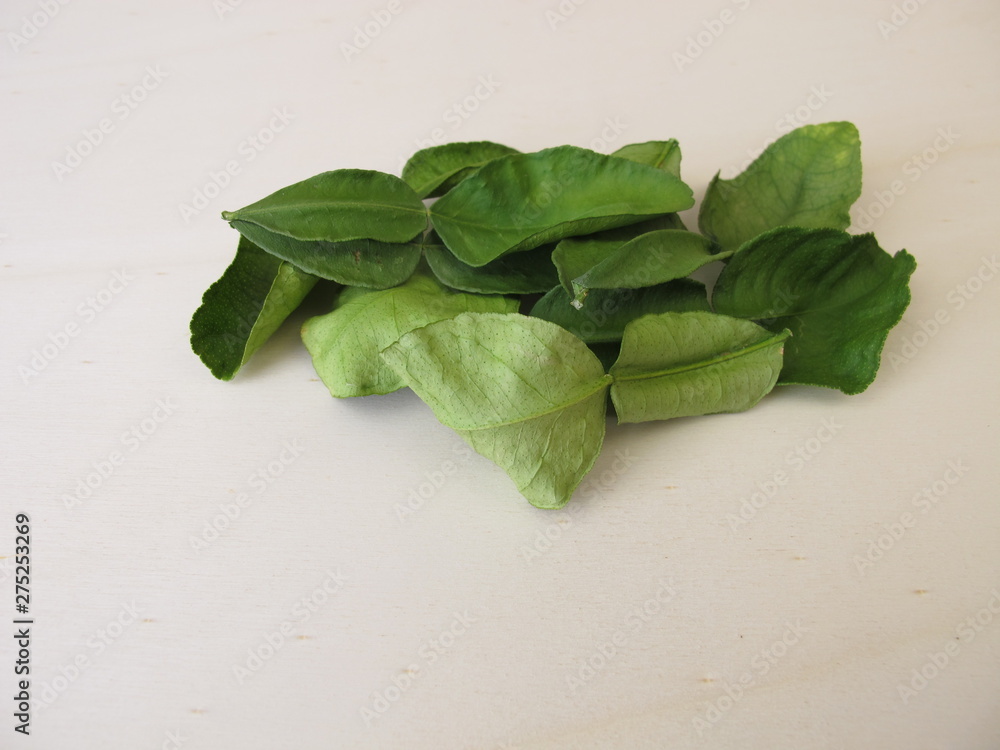 Dried kaffir lime leaves on a wooden board Dried kaffir lime leaves on a wooden board