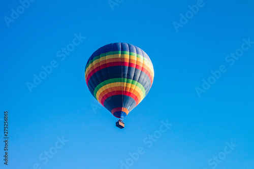 Colorful hot air balloons over blue sky.