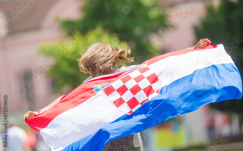 Fotografi Happy girl tourist walking in the street with croatian flag