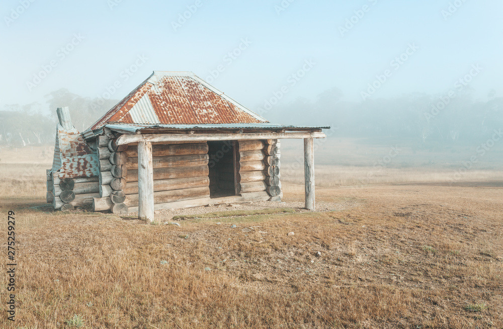 Simple chunky log cabin in the early morning mist.These huts are spread all around and provided free by the government for use in times of extreme weather Simple chunky log cabin in the early morning mist.These huts are spread all around and provided free by the government for use in times of extreme weather