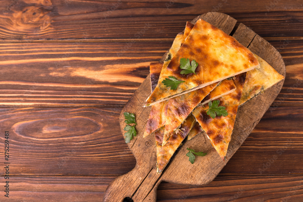 Khachapuri Megrelian with spinach and parsley. Pita bread with cheese