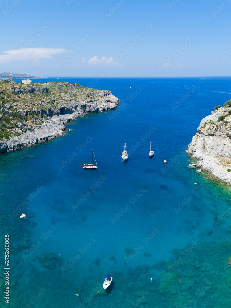 Aerial view of blue lagoon and yachts, island paradise. Popular touristic destination. Clear sea water. Greece, Rhodes
