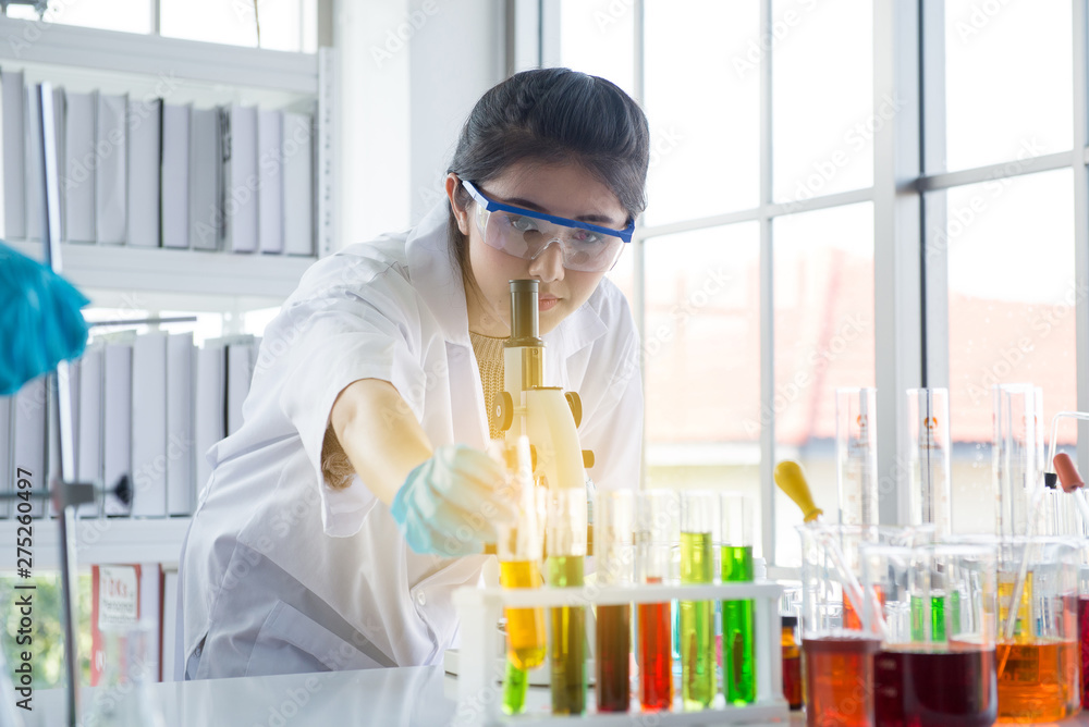 Scientist beautiful asian women working and looking medical chemicals sample in test tube at laboratory Scientist beautiful asian women working and looking medical chemicals sample in test tube at laboratory