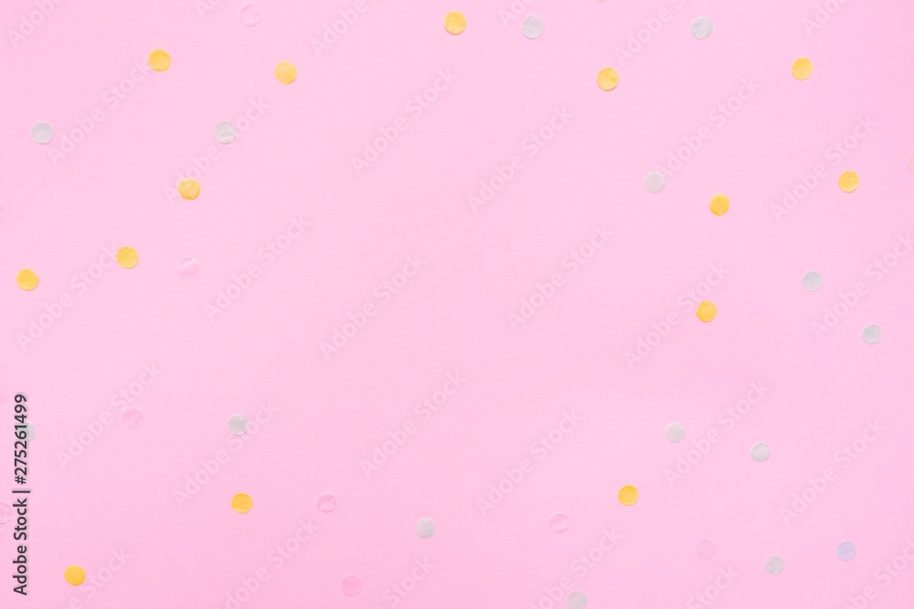 Pink pastel festive background with multicolored confetti. Copy space for your text. Flat lay style. Top view. 