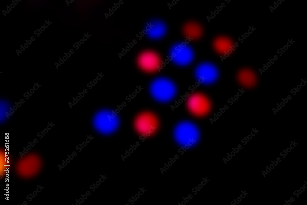 Abstract background with confetti on isolated black background. A place for your text. Blue and red confetti. Abstract background with confetti on isolated black background. A place for your text. Blue and red confetti.